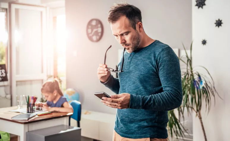 Father looking at mobile device Father looking at mobile device