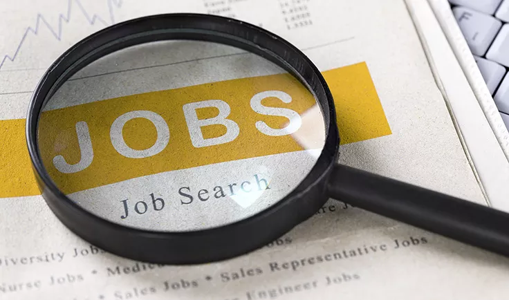 Magnifying glass highlighting the word “JOBS” on a job search page. Magnifying glass highlighting the word “JOBS” on a job search page.