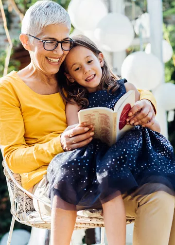 Old lady reading novel for her grand daughter

