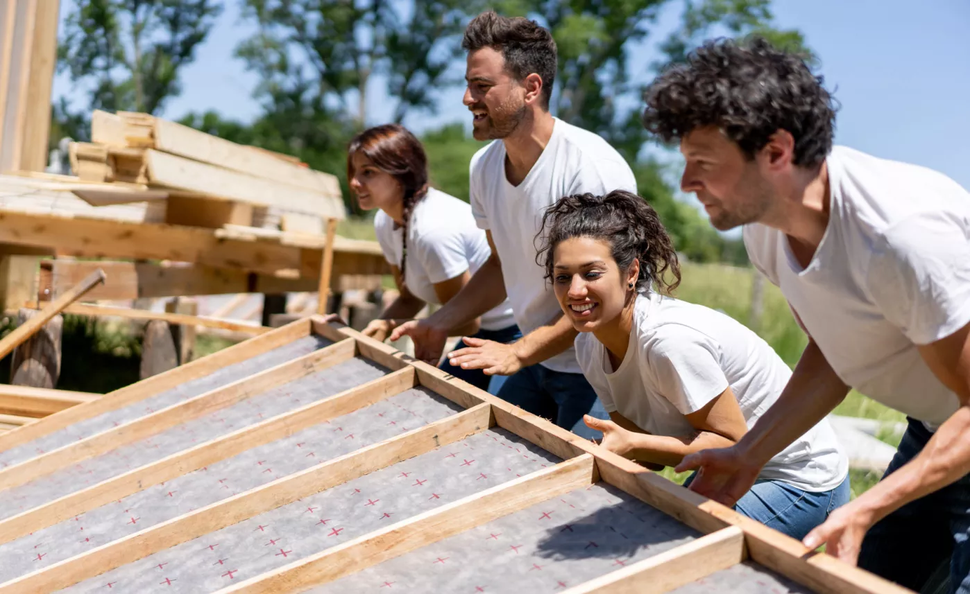  Group of volunteers constructing a home.

