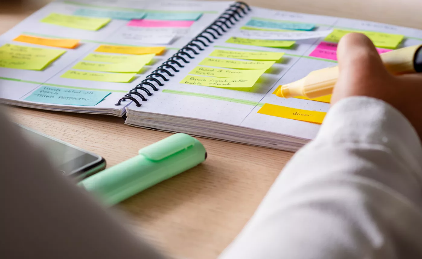  Day planner covered in Post-it notes
