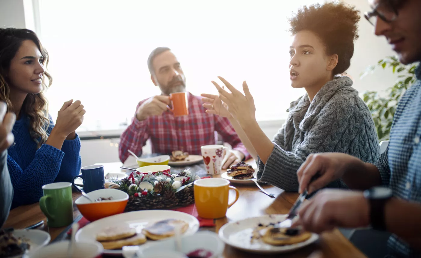  A multigenerational family having an important conversation over a holiday dinner
